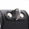 close-up of silver metal d-ring attached to black faux leather ball stretcher with stitched detailing