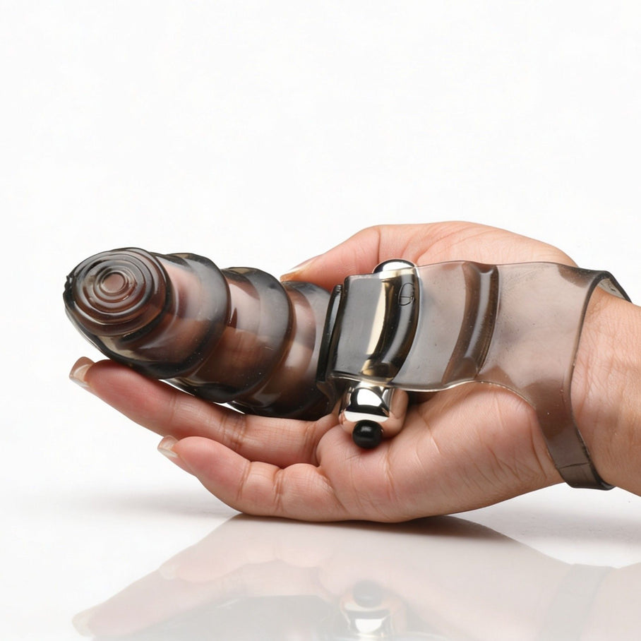 Bang Bang P-Spot Vibrating Finger Glove resting in a hand to demonstrate size, featuring a textured smoke-tinted sleeve and built-in vibrating bullet