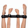 Deluxe Rigid Spreader Bar securing wrists and ankles in an overhead demonstration, featuring four padded adjustable cuffs connected by a rigid support bar