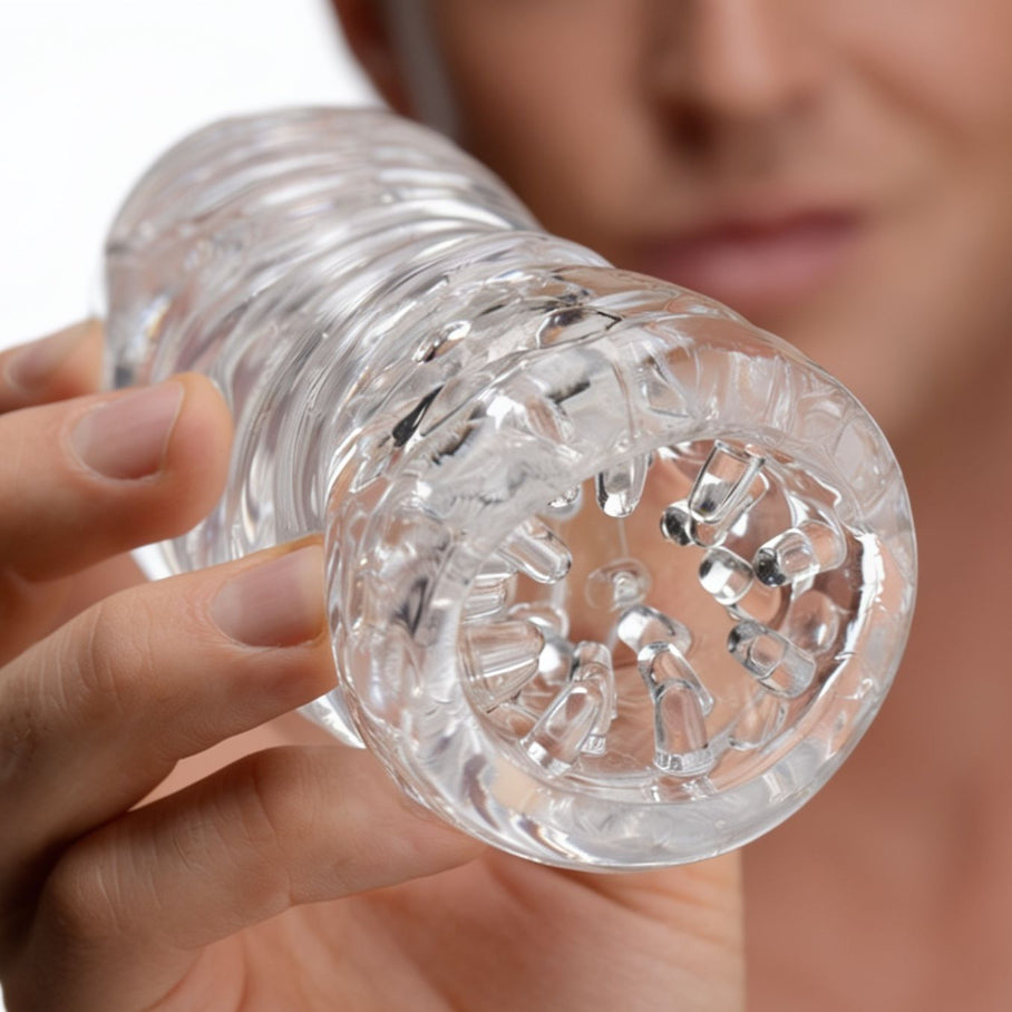 Close-up of the Palm-Tec LX20 Intense Stroker opening showcasing the clear sleeve material and detailed internal stimulation texture
