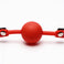 close-up of smooth red silicone ball on adjustable comfort ball gag with black strap