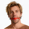 man wearing red silicone comfort ball gag with adjustable black strap and silver hardware