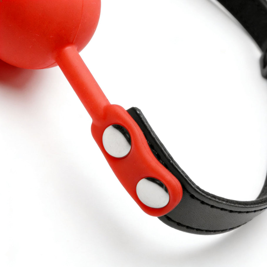 close-up of red silicone connector and black adjustable strap on comfort ball gag