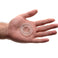 Universal Super-Stretch Cock Ring displayed in an open palm to demonstrate its compact size and clear flexible material