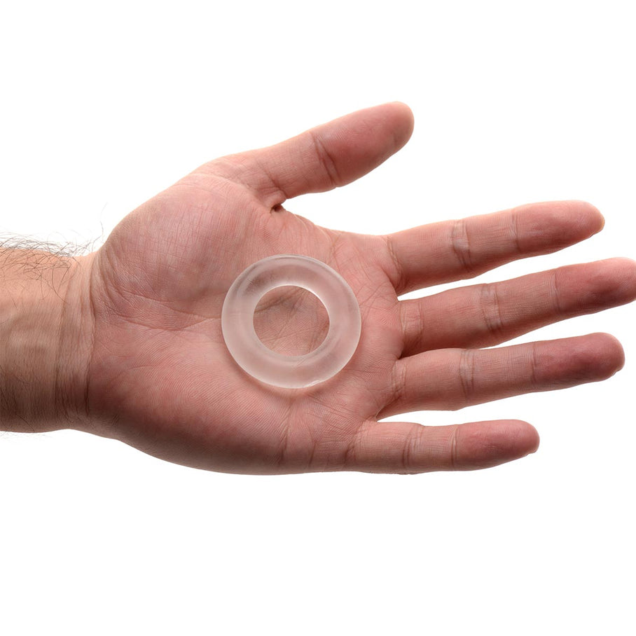 Universal Super-Stretch Cock Ring displayed in an open palm to demonstrate its compact size and clear flexible material