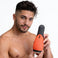 Model holding the Vibra Head Bionic Auto Stroker to demonstrate the compact size, ergonomic shape, and easy handheld use
